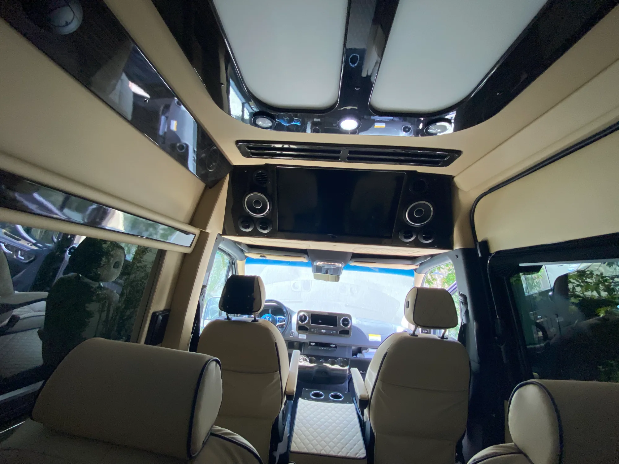 Overhead 32-inch HDTV and the cabin control console.