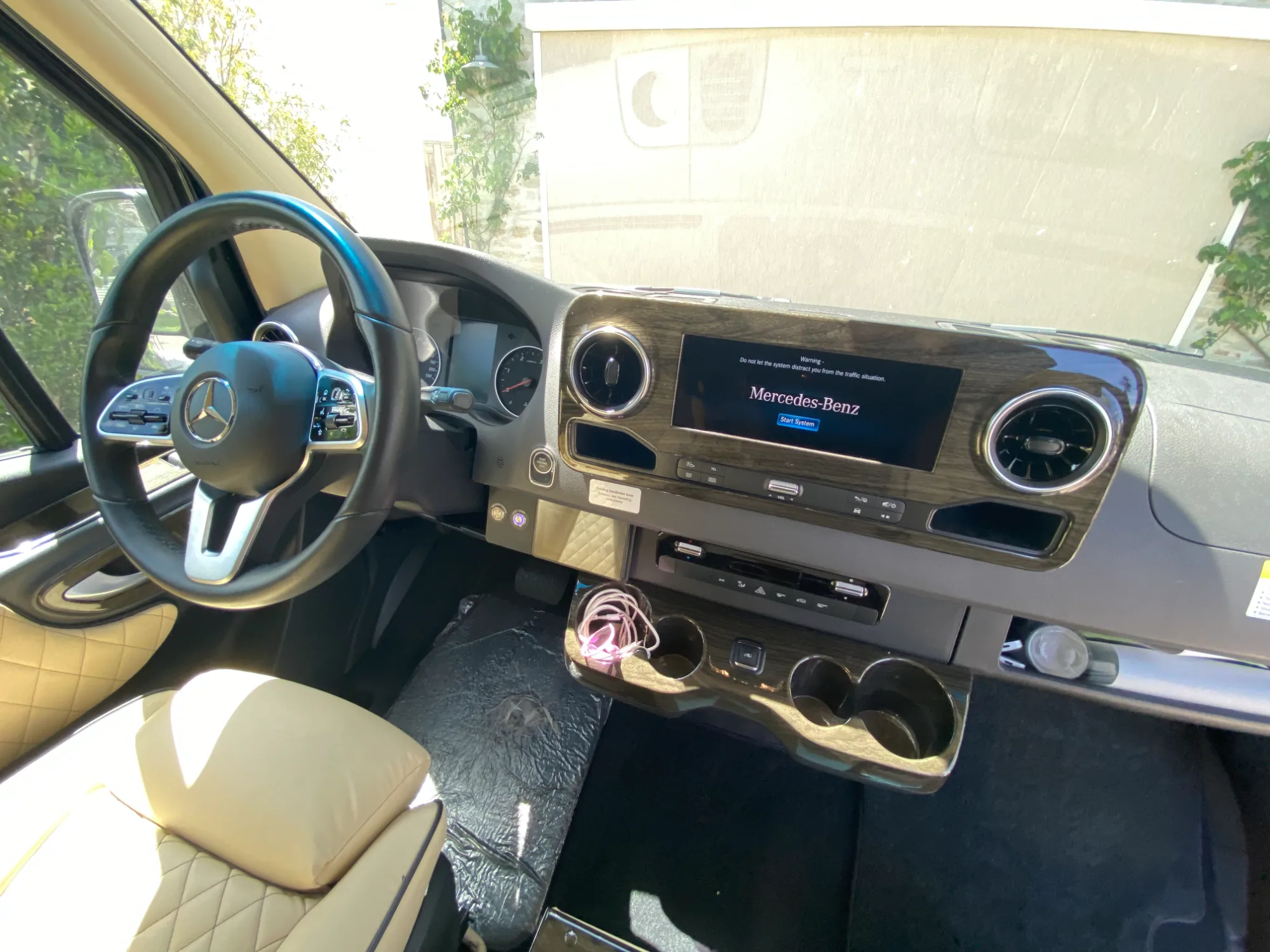 Cab interior — factory touchscreen and Black Denali burled wood console.