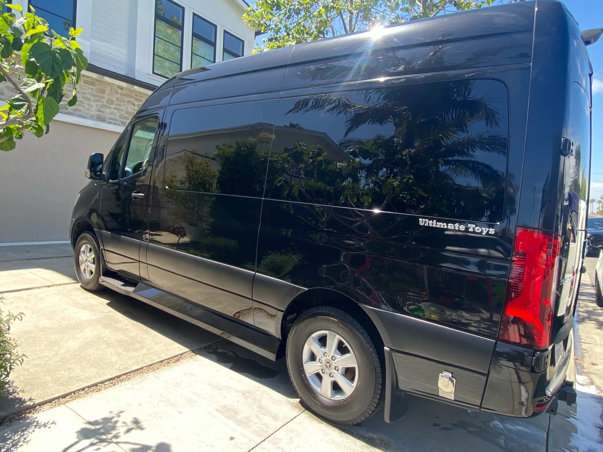 Driver-side profile of the black Sprinter with Ultimate Toys badging.