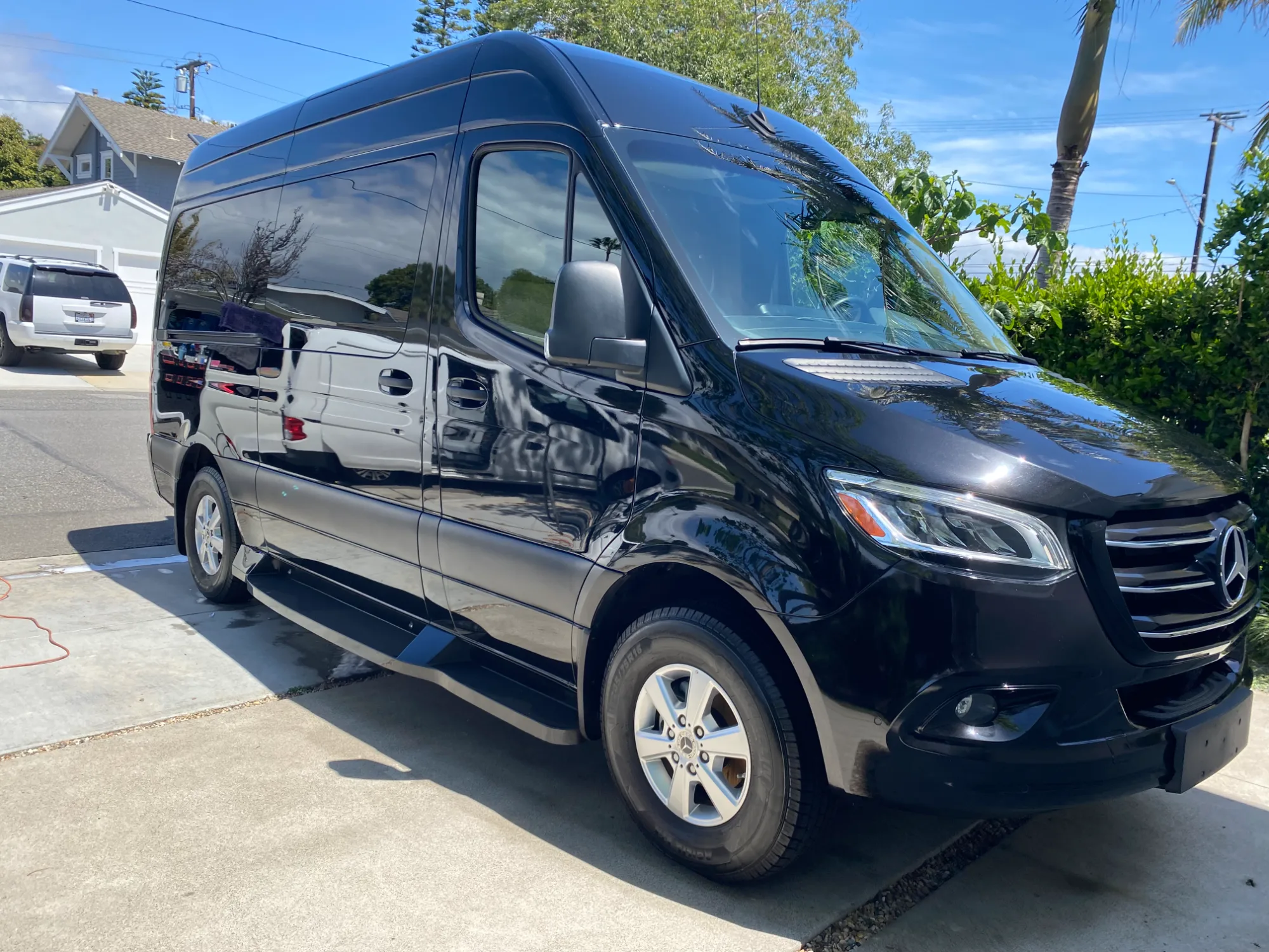 Black 2024 Mercedes-Benz Sprinter 2500 high-roof executive coach, exterior three-quarter view.